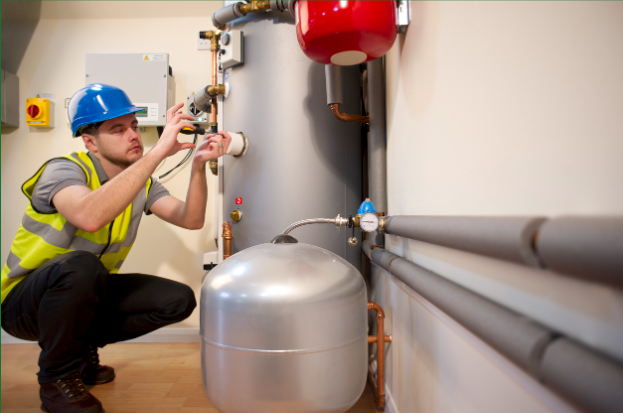 A technician performs service on a furnace