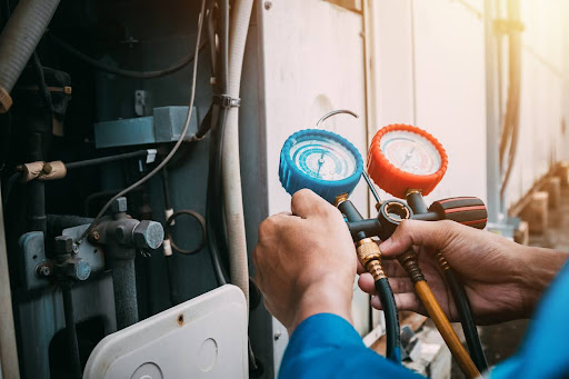 Technician is checking the air conditioner refrigerant leak.